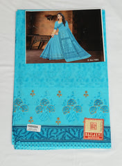 Blue embroidered fabric with a woman in a blue dress in the background