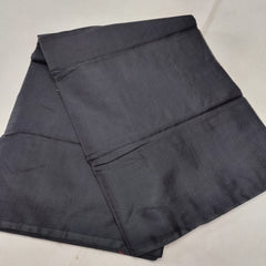 A folded blue Kota cotton plain saree with a solid pattern, displayed on a white background.