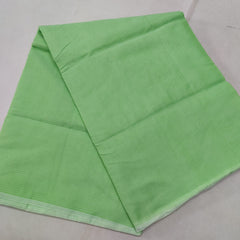 A folded Green Kota cotton plain saree with a solid pattern, displayed on a white background.