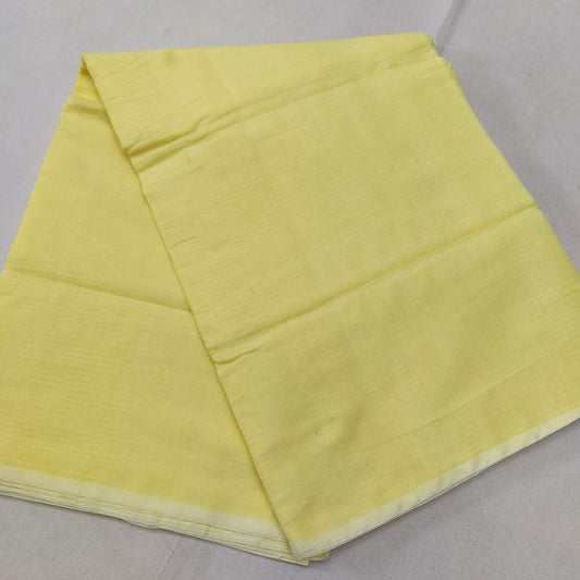 A folded Yellow Kota cotton plain saree with a solid pattern, displayed on a white background.