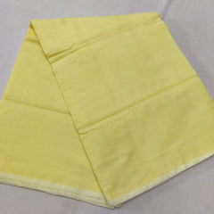 A folded Yellow Kota cotton plain saree with a solid pattern, displayed on a white background.