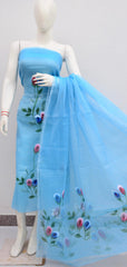 Mannequin wearing a light blue dress with floral embroidery on a plain background