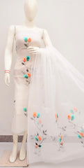 Mannequin wearing a white dress with floral embroidery on a plain background