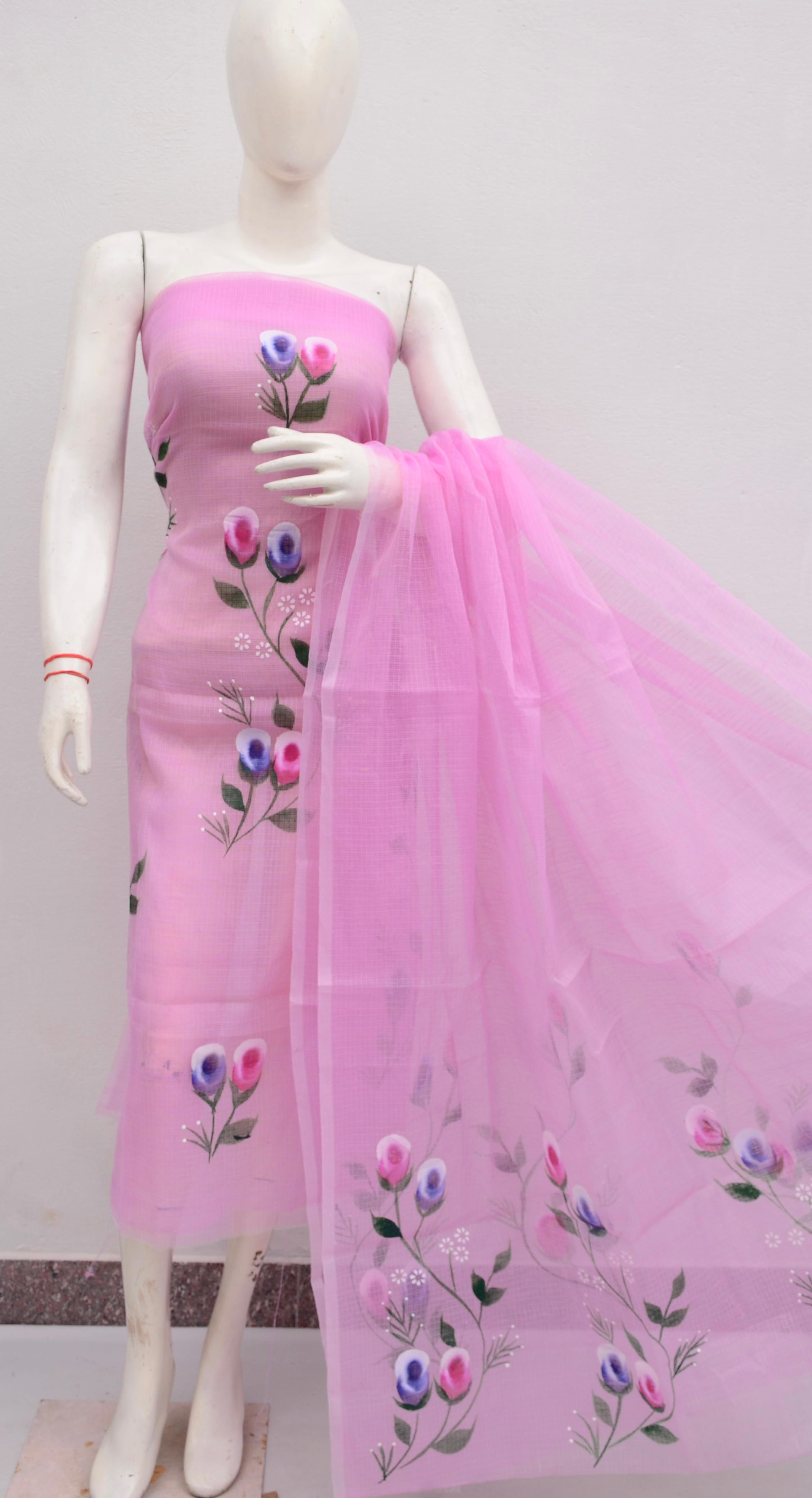 Mannequin wearing a pink dress with floral embroidery on a plain background