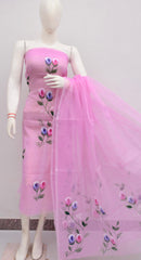 Mannequin wearing a pink dress with floral embroidery on a plain background