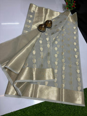 A collection of Banarasi Kora Organza Silk Sarees with Zari Work, displayed in various colors such as orange, blue, pink, yellow, and green, along with two saree blouses, placed on a white surface.