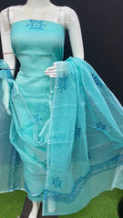 Mannequin wearing a turquoise embroidered saree with a plain background