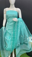Mannequin wearing a turquoise embroidered outfit with a matching dupatta on a black background