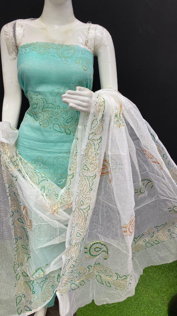 Mannequin wearing a turquoise dress with a white embroidered dupatta on a black background