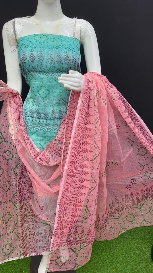 Mannequin wearing a turquoise top and pink dupatta with intricate patterns on a black background