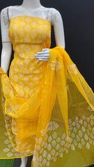 Yellow embroidered dress with a matching dupatta on a mannequin against a black background