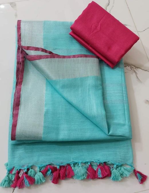 Turquoise fabric with pink trim and tassels on a white surface