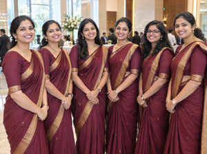 Team of women in matching uniform sarees for a corporate event